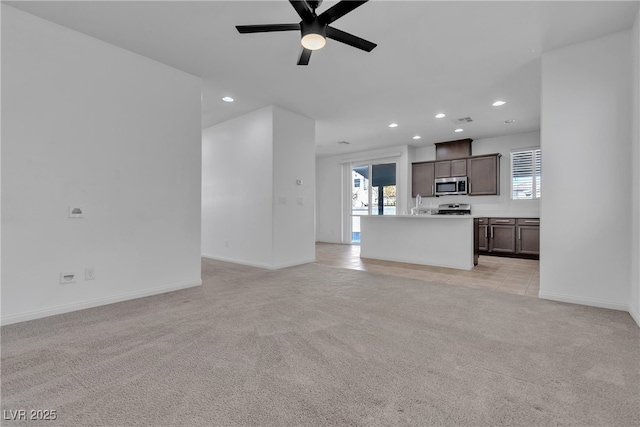 unfurnished living room with visible vents, baseboards, ceiling fan, light carpet, and recessed lighting