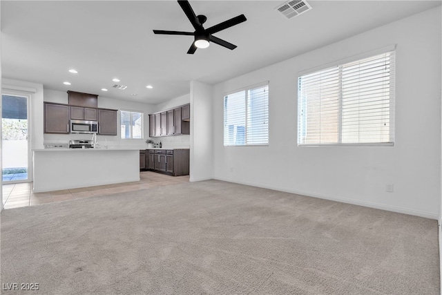 unfurnished living room with visible vents, recessed lighting, baseboards, light colored carpet, and ceiling fan