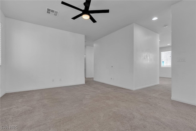 carpeted empty room with recessed lighting, a ceiling fan, visible vents, and baseboards