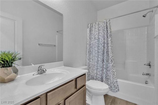 full bathroom featuring wood finished floors, toilet, vanity, and shower / bath combo