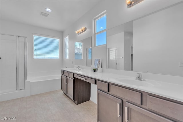 full bathroom featuring visible vents, a shower stall, and a sink