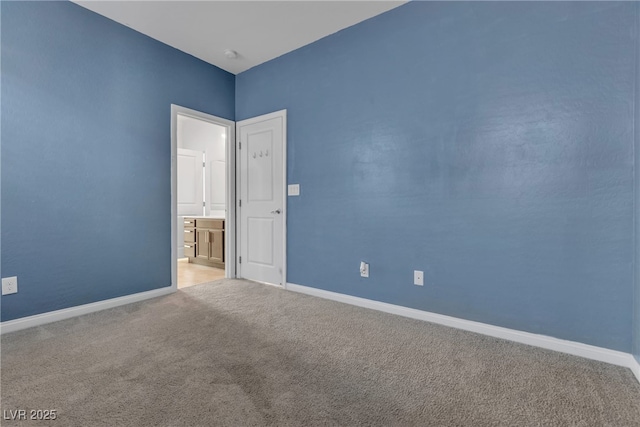 carpeted spare room with baseboards