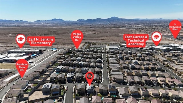 birds eye view of property featuring a mountain view and a residential view