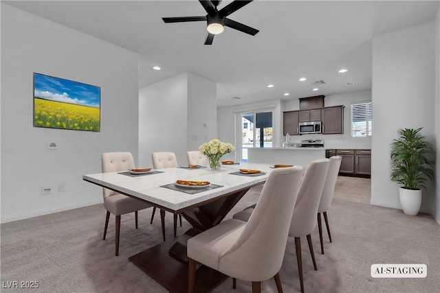 dining room with ceiling fan, recessed lighting, baseboards, and light carpet