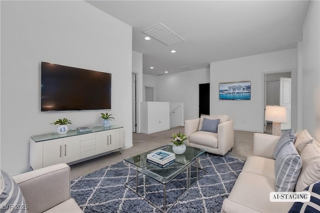 living area with visible vents, recessed lighting, and carpet