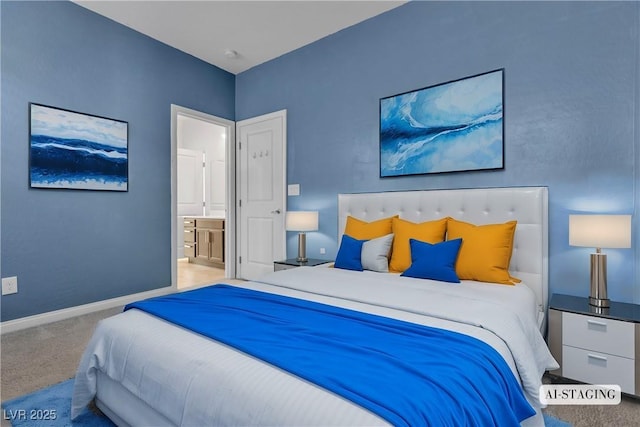 carpeted bedroom featuring ensuite bath and baseboards