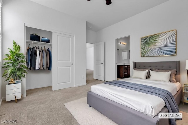 carpeted bedroom featuring a ceiling fan, baseboards, a closet, and ensuite bathroom