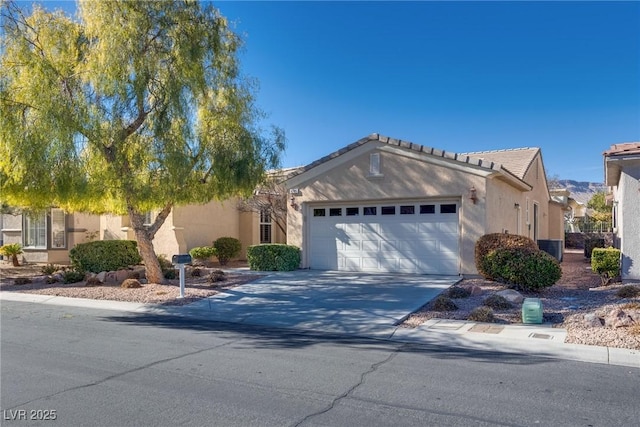 view of front of property featuring concrete driveway, a tiled roof, an attached garage, central air condition unit, and stucco siding