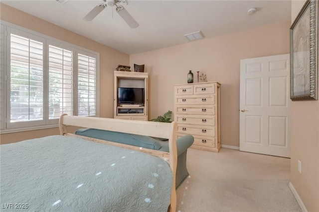 bedroom featuring a ceiling fan, light colored carpet, visible vents, and baseboards