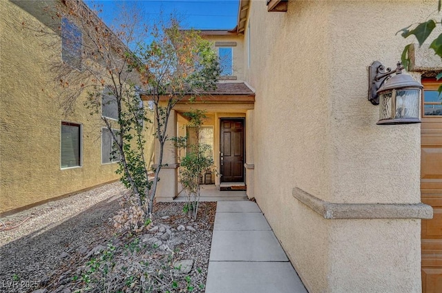 view of exterior entry with stucco siding