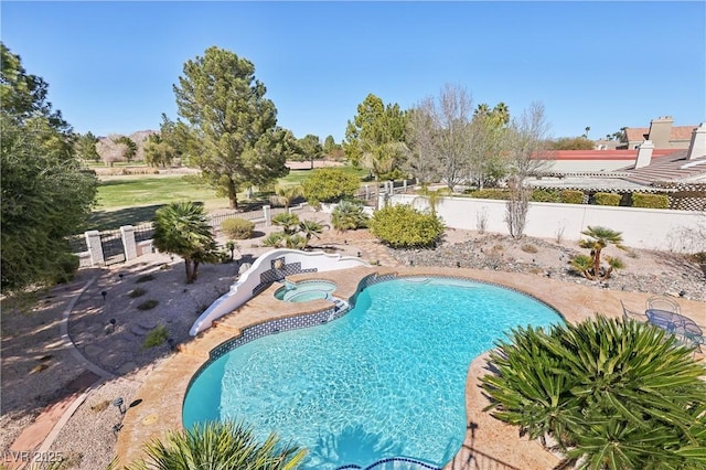 view of pool with a fenced in pool, fence, and an in ground hot tub