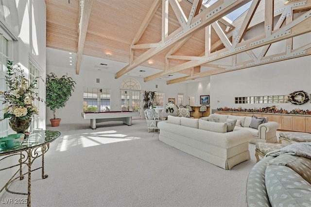 carpeted living area with high vaulted ceiling, pool table, beamed ceiling, and wooden ceiling