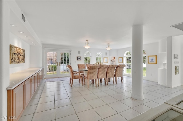 dining area featuring a wealth of natural light, french doors, visible vents, and light tile patterned floors