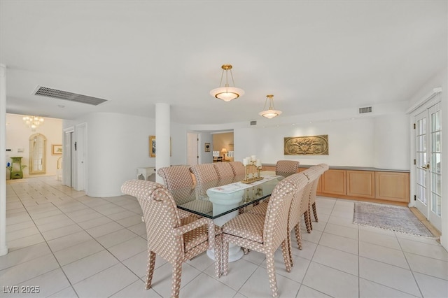 dining area with french doors, light tile patterned flooring, and visible vents