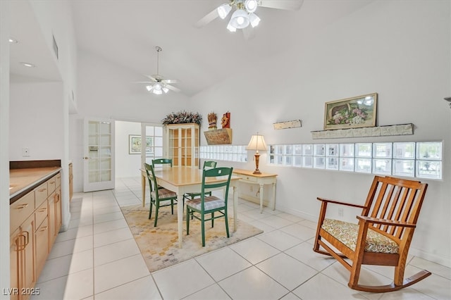 dining room with lofted ceiling, ceiling fan, light tile patterned floors, and french doors