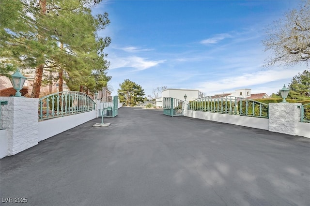 view of road with a gate and street lights