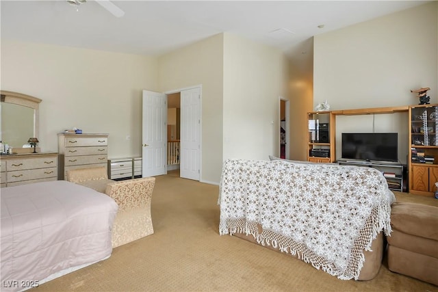 bedroom with carpet floors and a towering ceiling