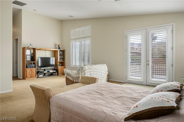 bedroom featuring lofted ceiling, light colored carpet, visible vents, access to exterior, and baseboards