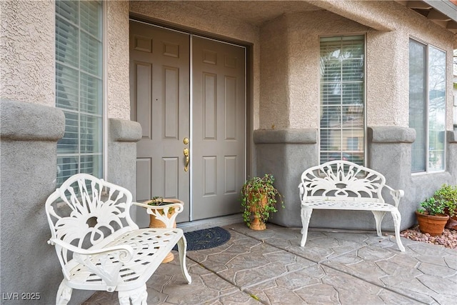 entrance to property with stucco siding