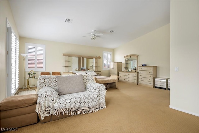 living area with vaulted ceiling, carpet, visible vents, and a ceiling fan