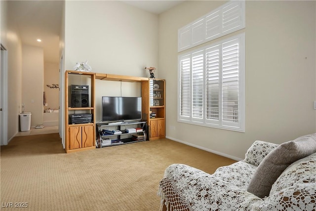 carpeted living room with baseboards