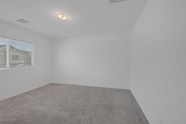 carpeted empty room featuring baseboards and visible vents