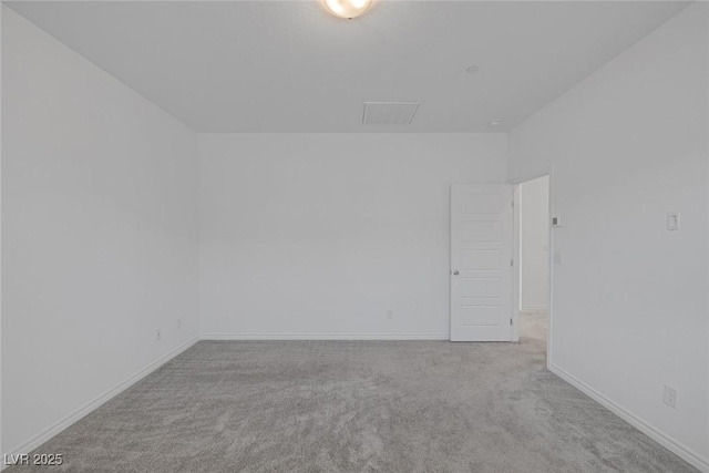 carpeted empty room featuring baseboards