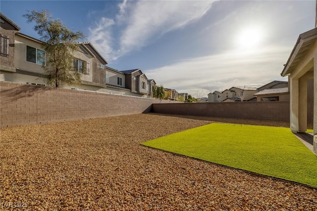 view of yard featuring a residential view and a fenced backyard