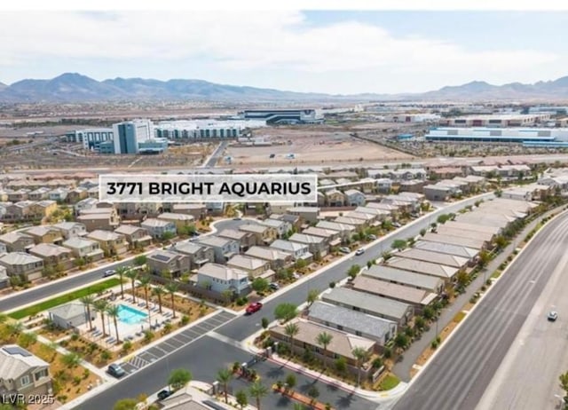 birds eye view of property with a mountain view