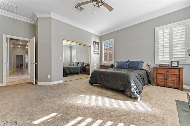 carpeted bedroom featuring a closet, visible vents, crown molding, and baseboards