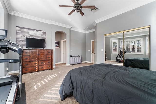 bedroom featuring visible vents, arched walkways, baseboards, ornamental molding, and carpet floors