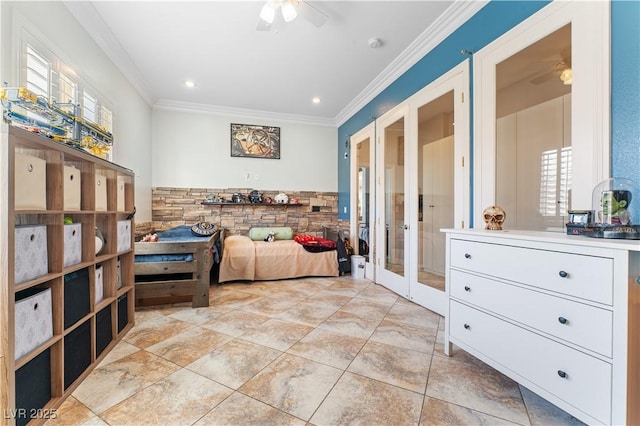 bedroom with a wainscoted wall, crown molding, and french doors