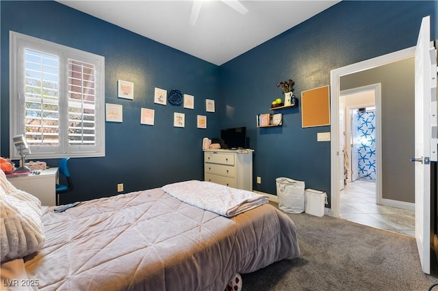 bedroom featuring carpet, tile patterned flooring, ceiling fan, and baseboards