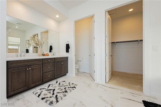 full bath featuring marble finish floor, a sink, toilet, and recessed lighting