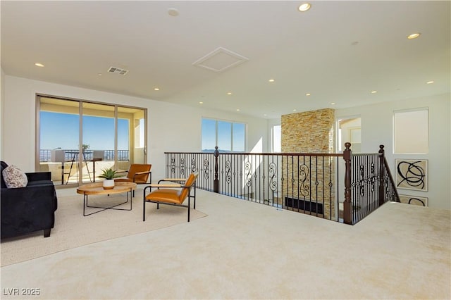 living area with recessed lighting, carpet flooring, visible vents, and a healthy amount of sunlight