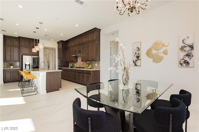 dining space with marble finish floor, recessed lighting, visible vents, and an inviting chandelier