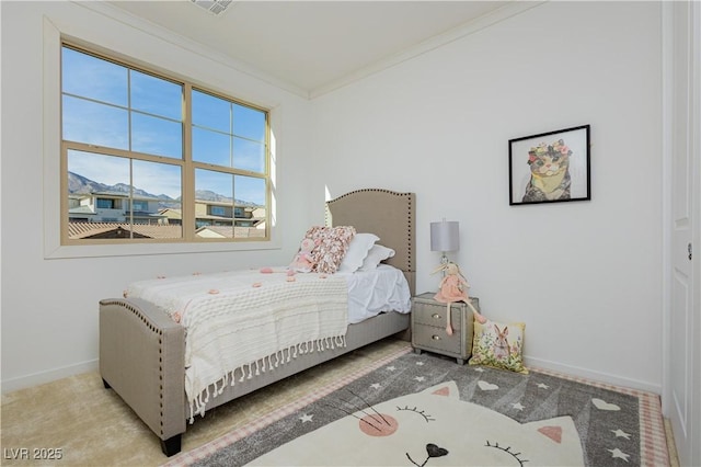 bedroom with ornamental molding, carpet flooring, and baseboards