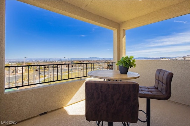 view of patio / terrace featuring a mountain view and a balcony