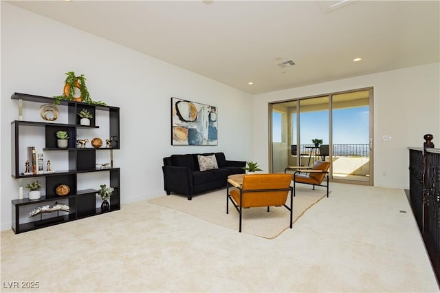 living room featuring recessed lighting, light colored carpet, and visible vents