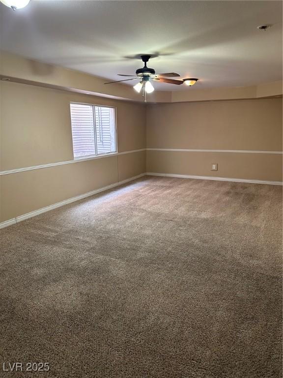 empty room featuring carpet flooring, ceiling fan, and baseboards