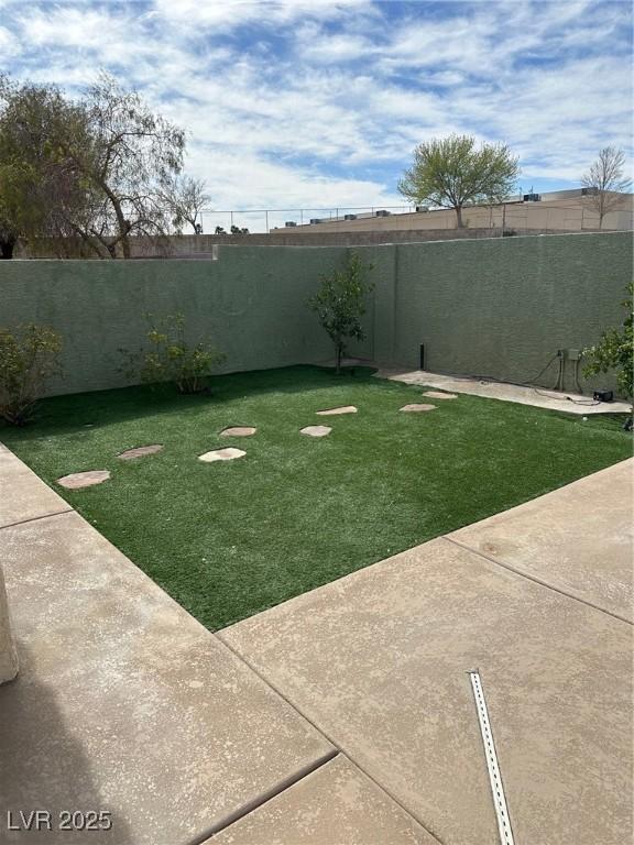 view of yard featuring a patio area and a fenced backyard