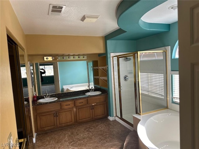 full bath featuring a garden tub, a sink, visible vents, and a shower stall