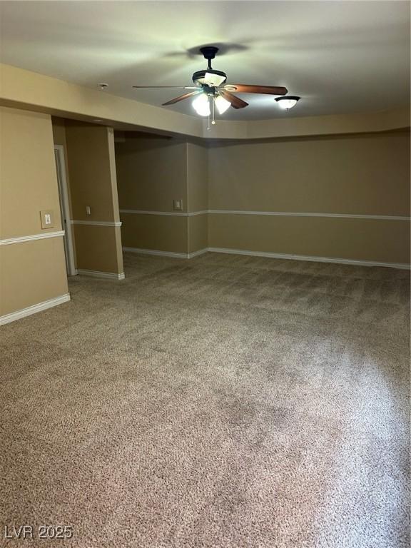 interior space with a ceiling fan and baseboards