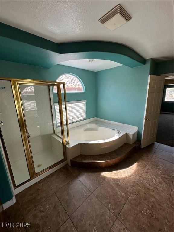 full bath with a healthy amount of sunlight, visible vents, a garden tub, and a shower stall