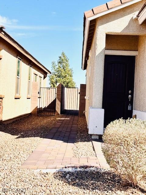 view of property exterior featuring a gate and stucco siding