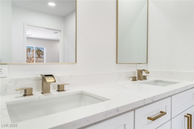 full bath with double vanity and a sink