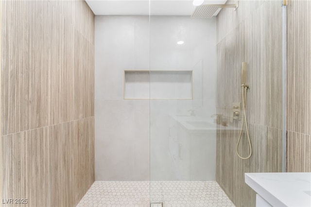 bathroom featuring tile patterned flooring, walk in shower, and tile walls