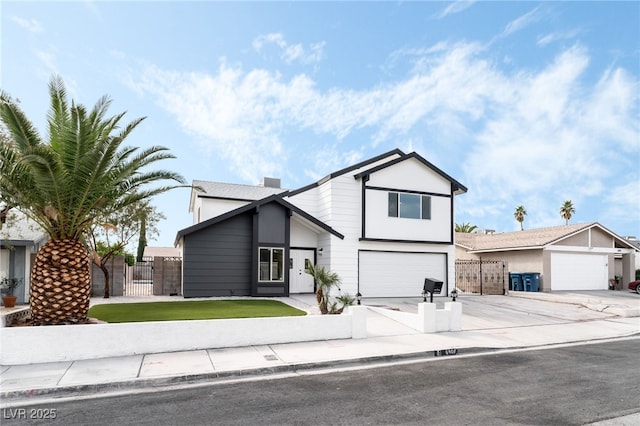 view of front of property with a garage, concrete driveway, fence, and a gate