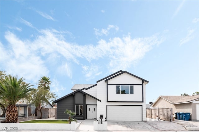 view of front of house featuring a garage, concrete driveway, and fence