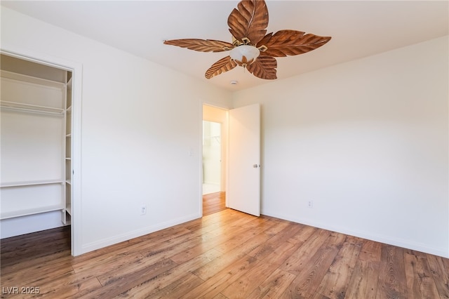 unfurnished bedroom with ceiling fan, baseboards, and wood finished floors